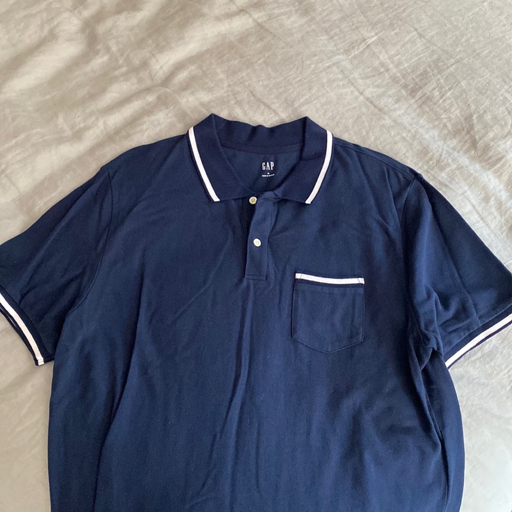 Like new.  Navy with white tip polo shirt